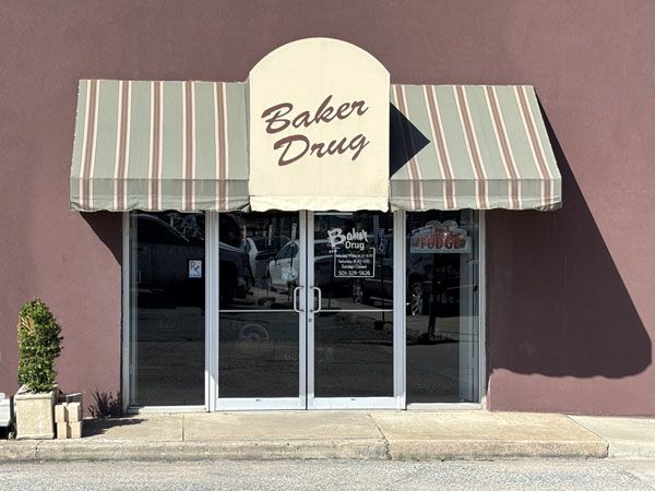 Baker Drug Store and Gift Shop entrance with striped canopy